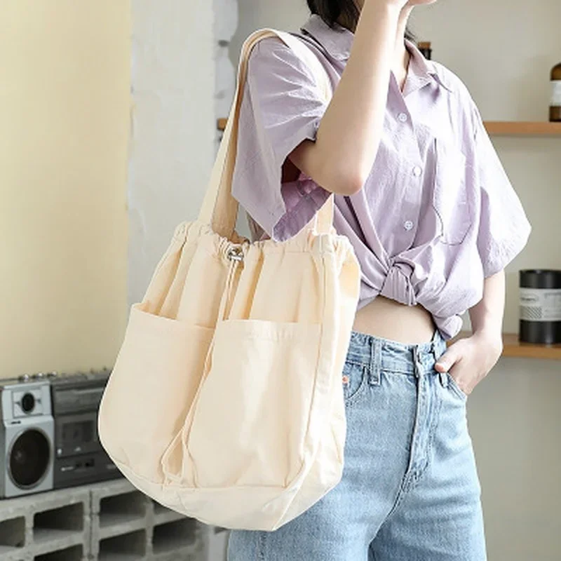 

2023 New Canvas Bag Women's One Shoulder Drawstring Multi Pocket Japanese Simple Large Capacity Casual Versatile Tote Bag