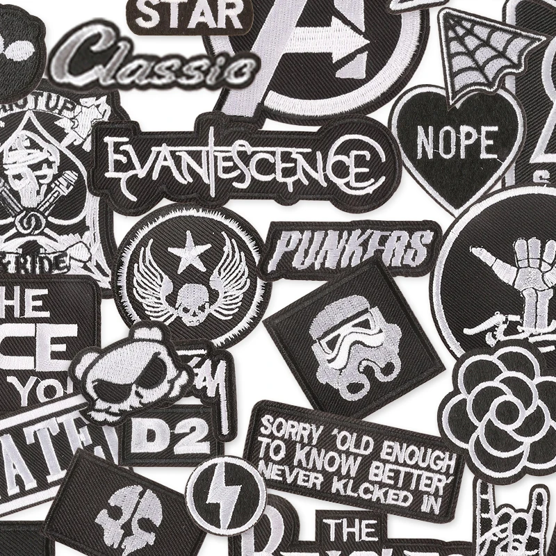 Collection of various black and white patches with different designs and text.