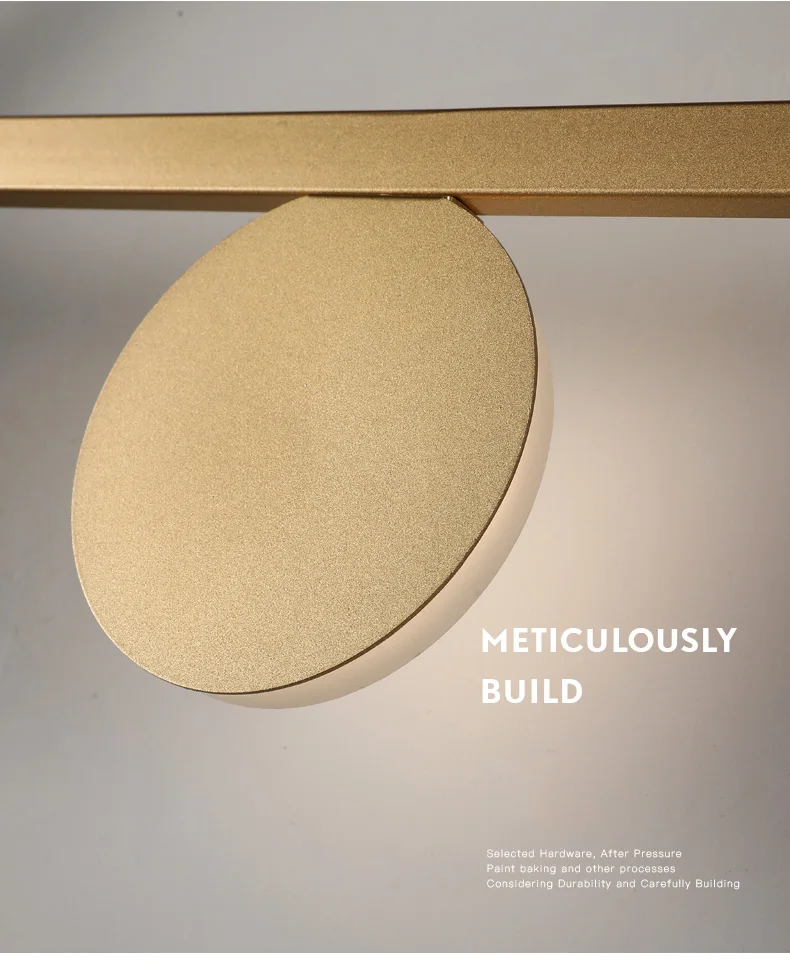 A minimalist light fixture with the words meticulously build on it, featuring a matte gold finish and Scandinavian design.