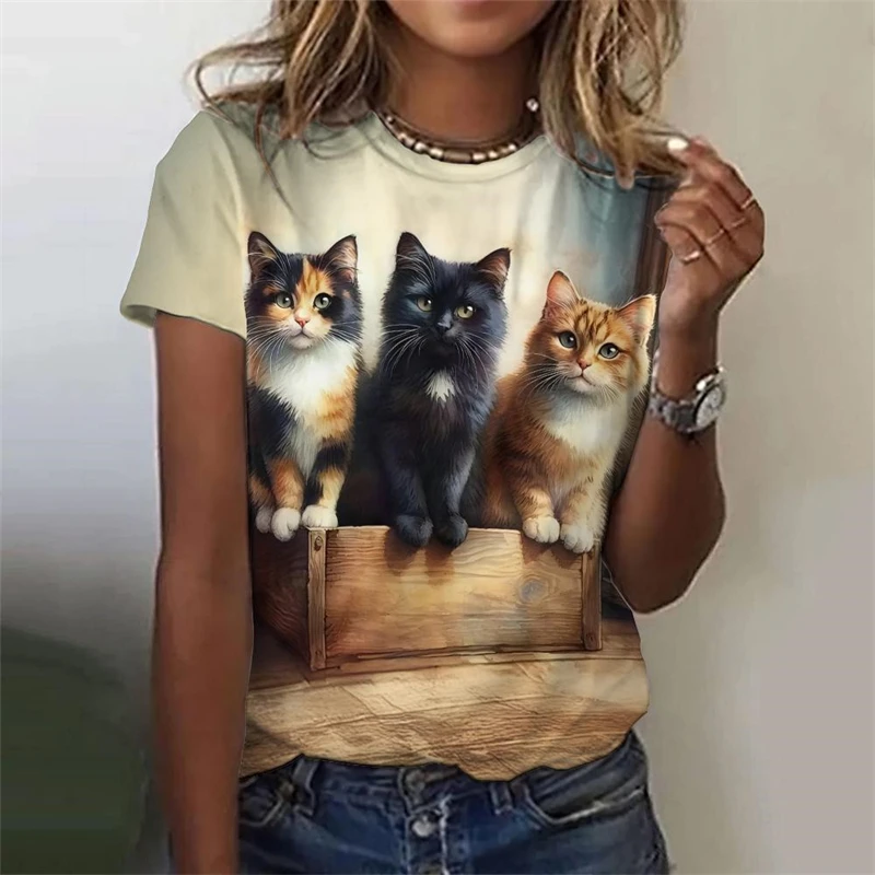 Woman wearing a casual cream-colored t-shirt with a realistic 3D print of two cute kittens sitting close together.