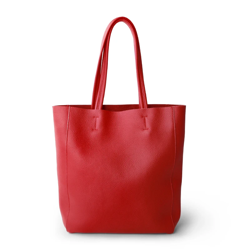 A red leather tote bag with two handles, standing upright on a white background.