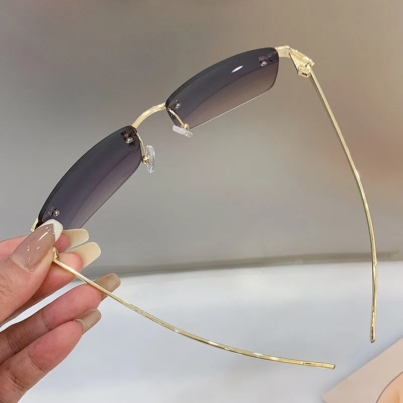 Stylish rimless rectangle sunglasses with tinted lenses and gold temples
