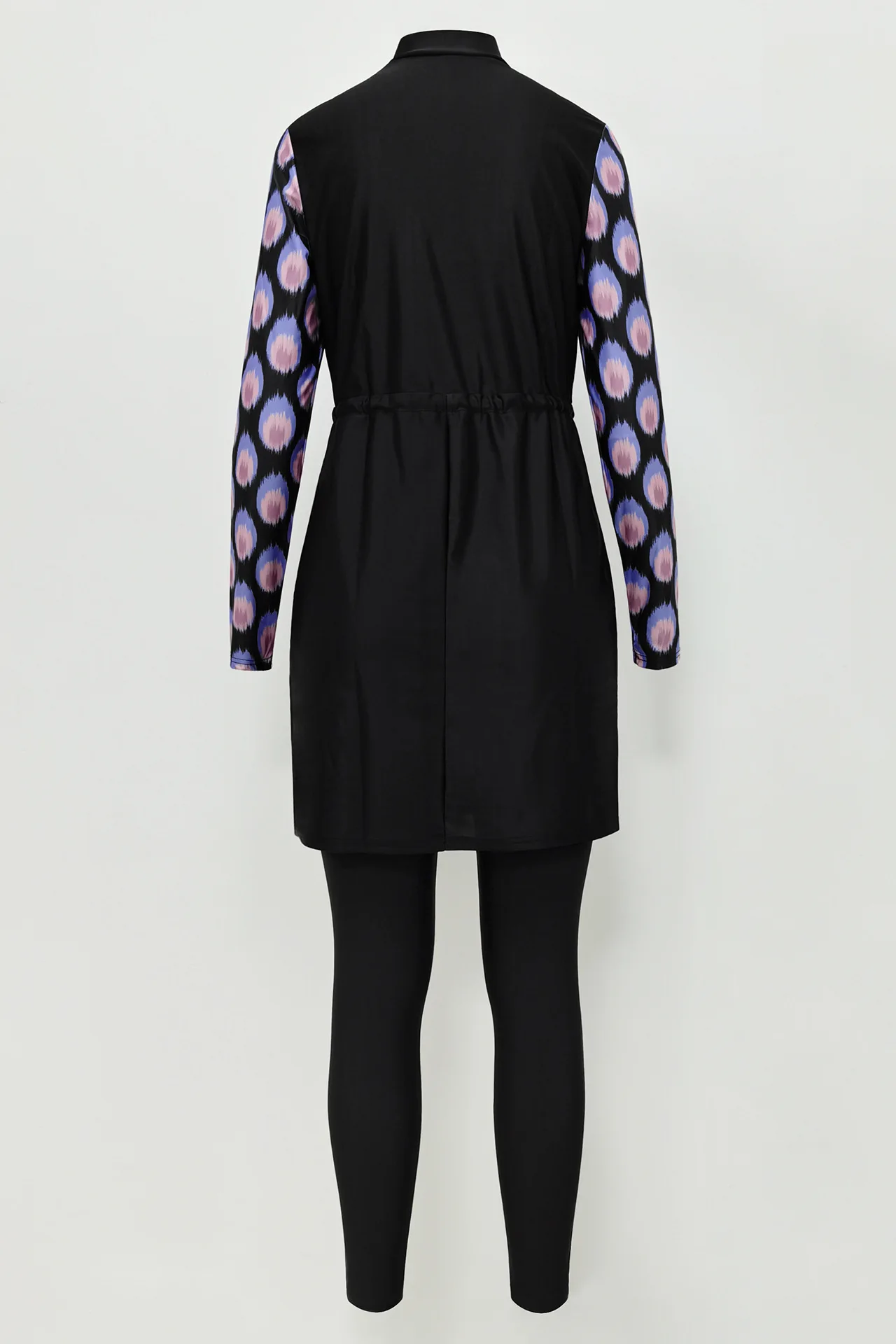Elegant modest swimwear with purple and pink circle design and sleek black skirt for full coverage.