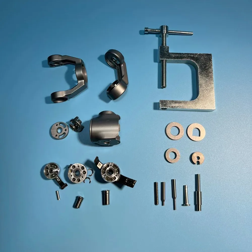 Pièces du kit outil de démontage du bras d'arbre de moteur à cardan pour DJI Mini 1/2/SE, Mavic 2, Air 1/2 disposées sur fond noir