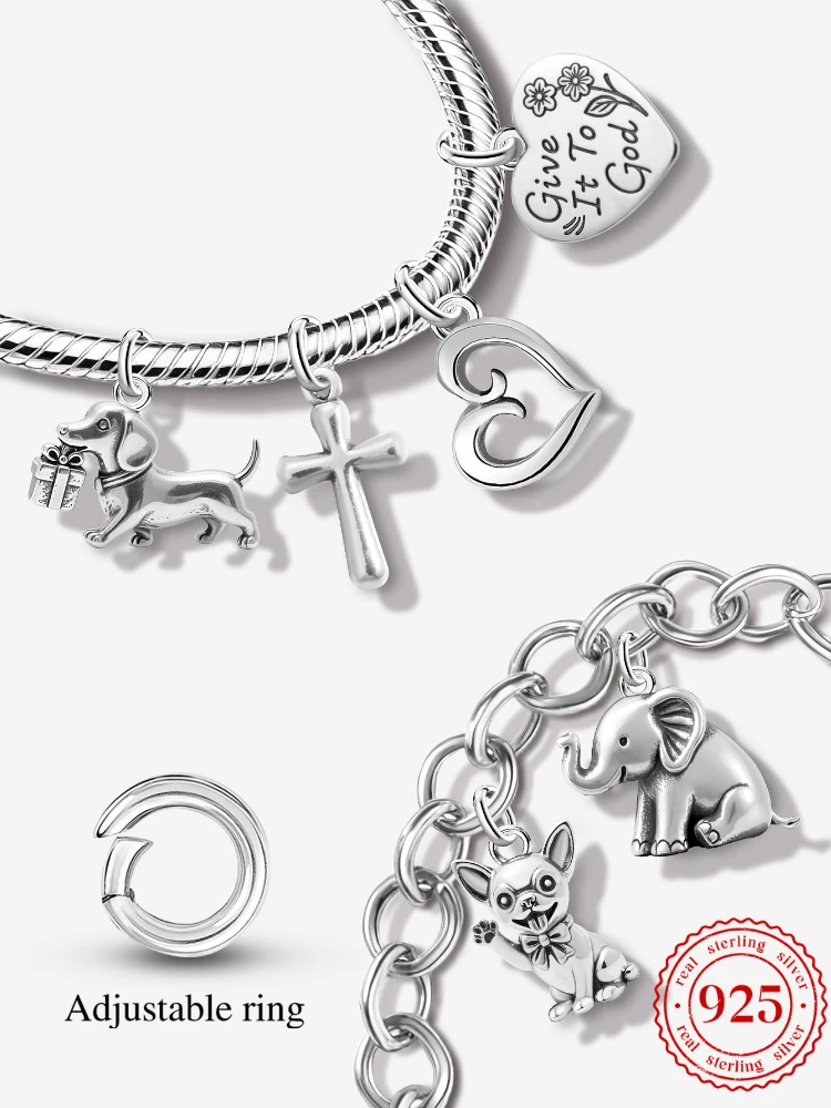 925 sterling silver vintage style charms including a cross, heart, and dachshund dog attached to a silver link bracelet.