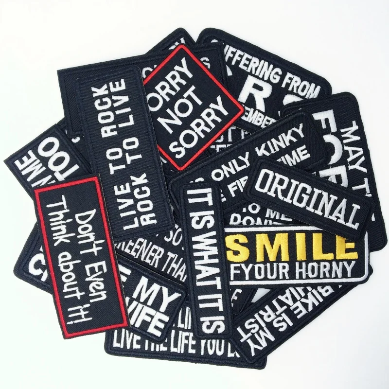 Funny embroidered text patches with sarcastic and edgy quotes like "Smile if you're horny", "I'm not listening", and "May the force be with you", arranged in a 20-piece pack