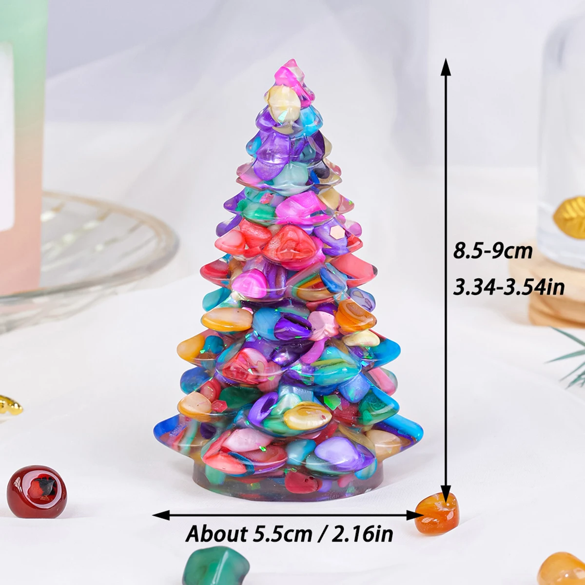 A unique Christmas tree shaped figurine, featuring a blend of pink Rose Quartz and golden-brown striped Tiger's Eye crystal chips, likely set in a resin base.