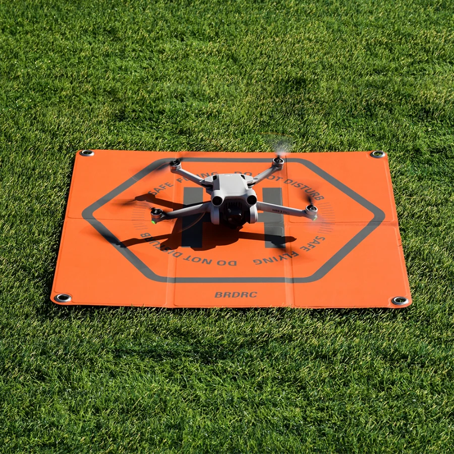 Gros plan sur la texture antidérapante du tapis d'atterrissage pliable pour drones DJI, avec logo DJI.