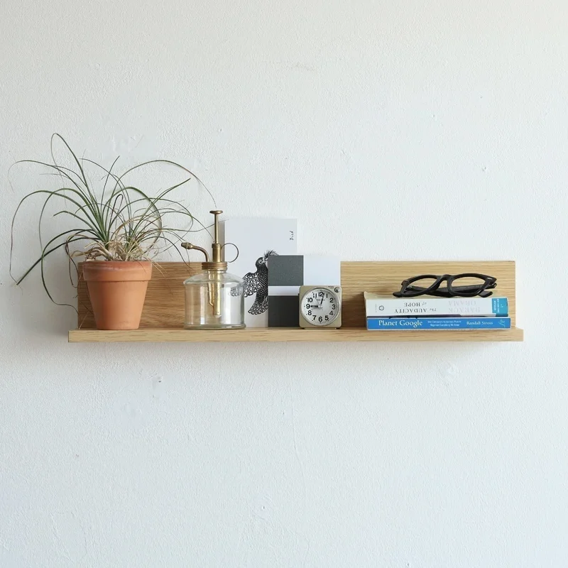 There is a small wooden frame on the wall, a flat partition in the bedroom and kitchen, and a