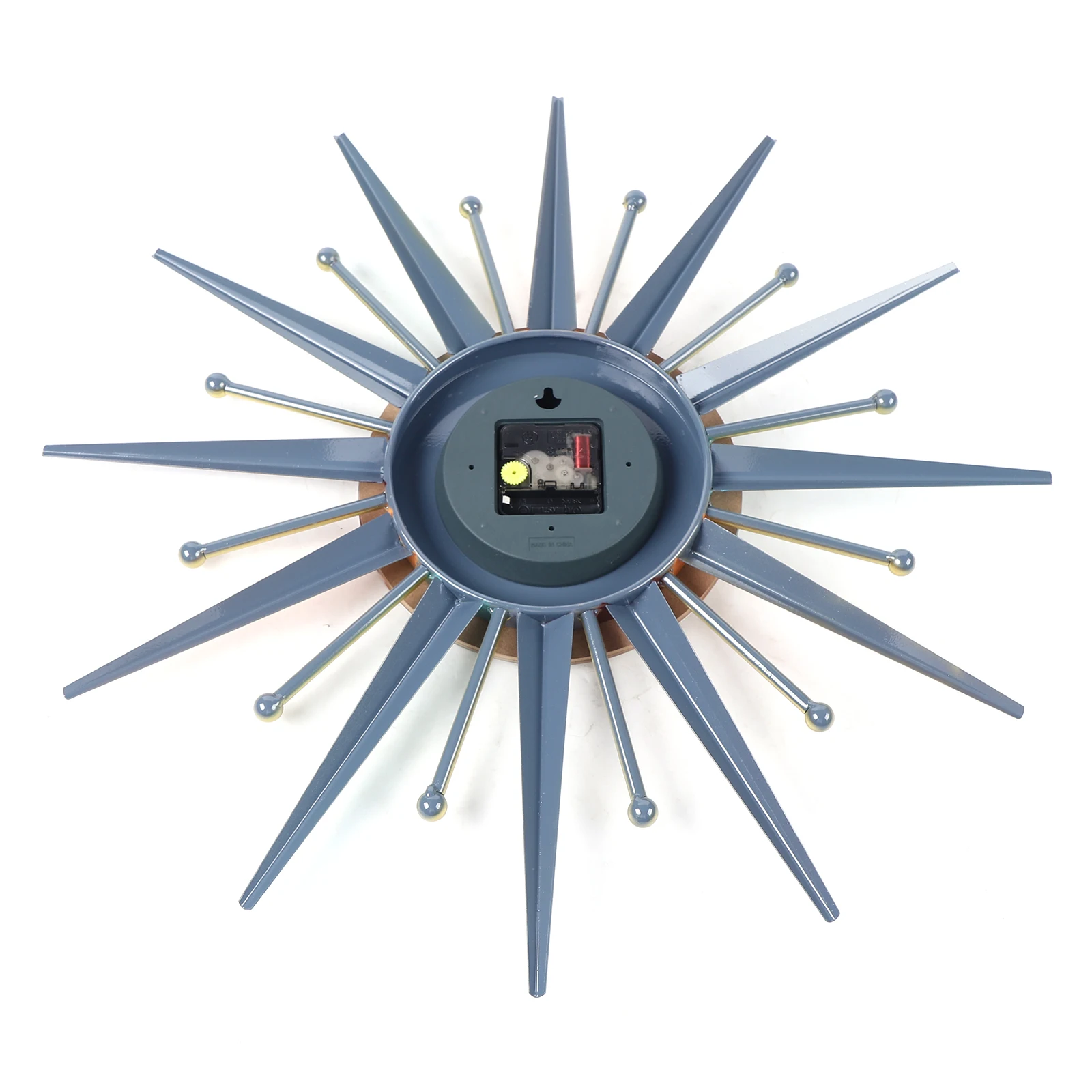 The Sunburst Wall Clock features blue pointed rays with gold-tipped accents, shown from the back to display its battery compartment and mounting hardware.