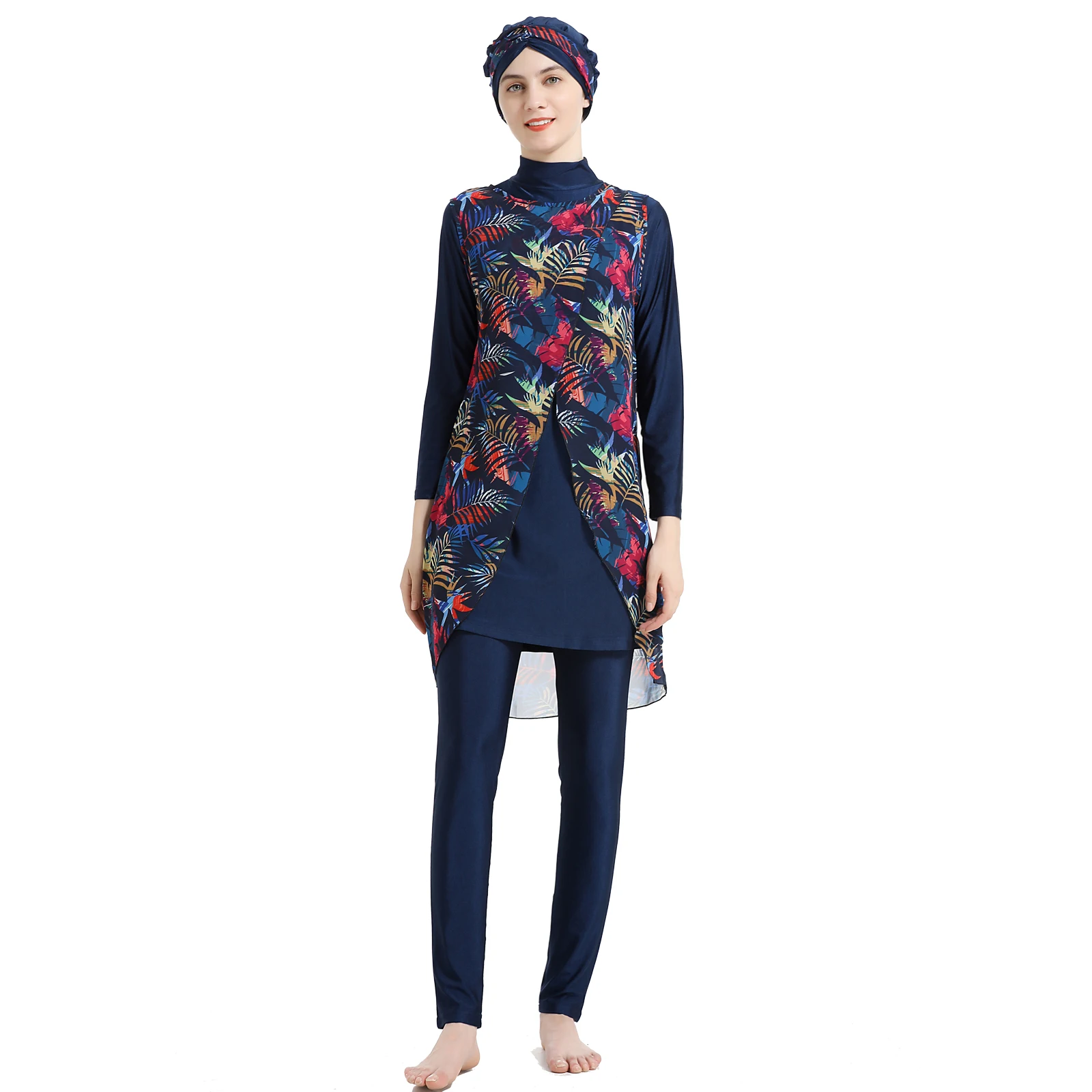 Model seated at beachside wearing navy burkini