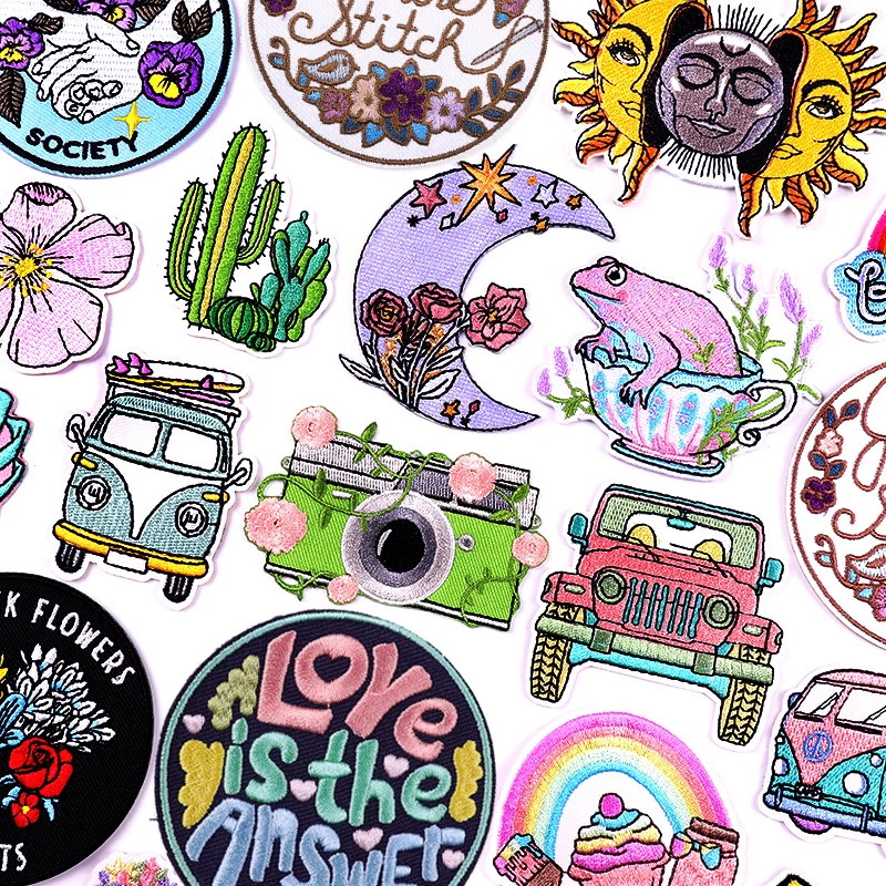 Boho embroidered patches with cameras, retro vans, flowers, sun and moon motifs, and inspirational quotes on white background