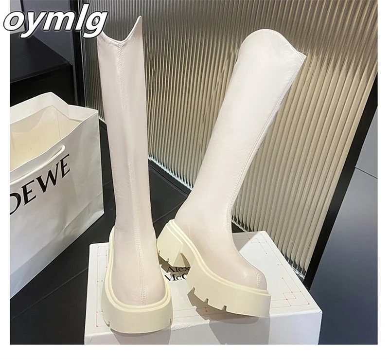 Thick heeled boots that are no less than knee high and appear slim with V-shaped boots