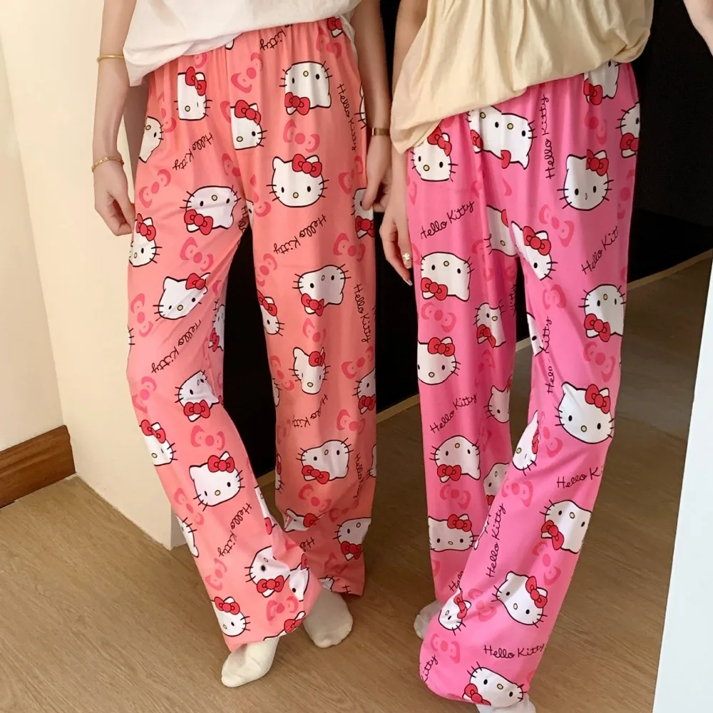 A pair of loose-fitting Hello Kitty pajama pants with a charming cartoon print pink and red