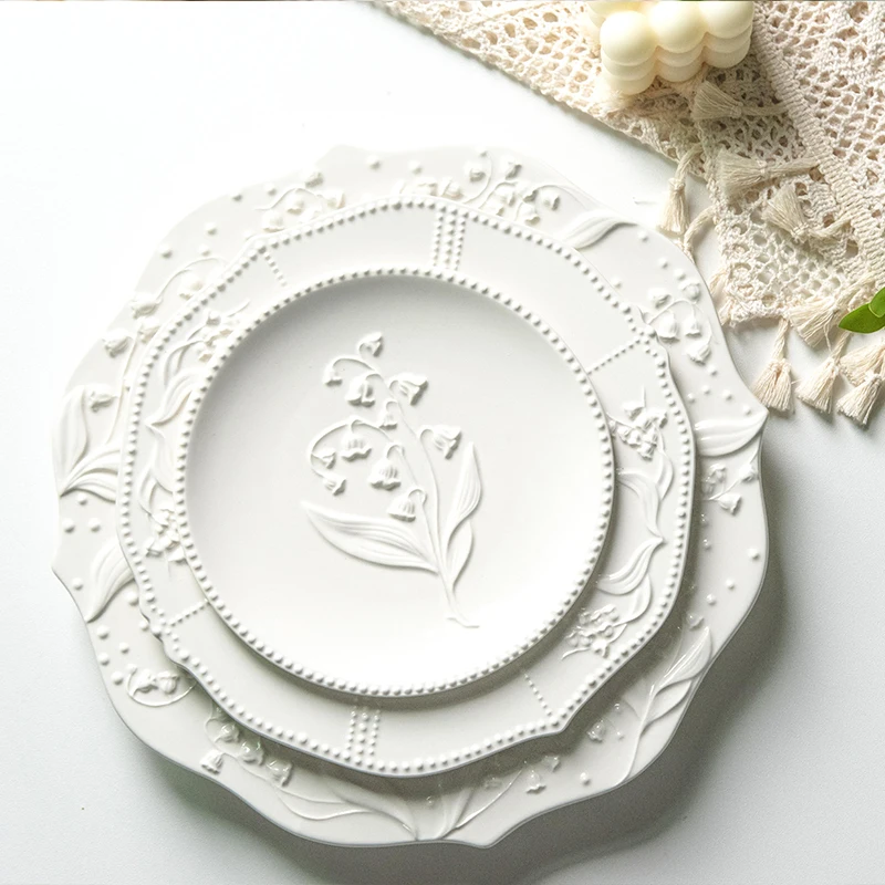 

A stunning set of plates, lily of the valley flower relief cream colored plates, mesh red ins dessert plates, cake plates, table