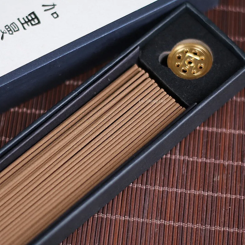 Open box of Chinese Stick Incense with small brass holder