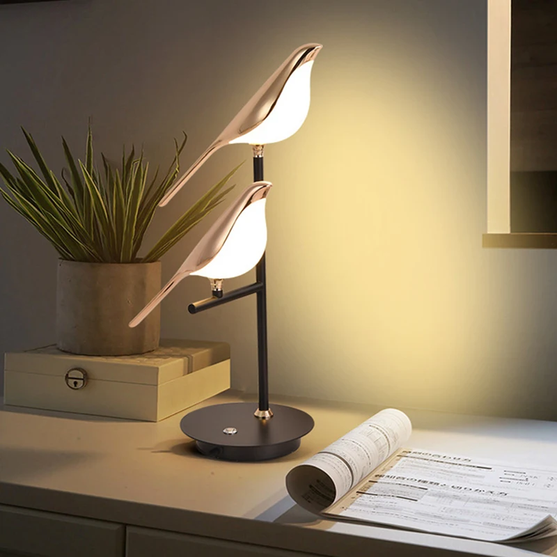 A modern accent piece, a desk lamp with a unique design, illuminated next to an open book on a table.