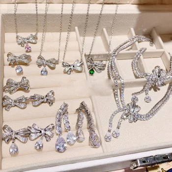 2023 Women Brilliant Bow Tie Earrings Plated 18K Gold Exquisite Water Drops Exaggerate Necklace Ring 1