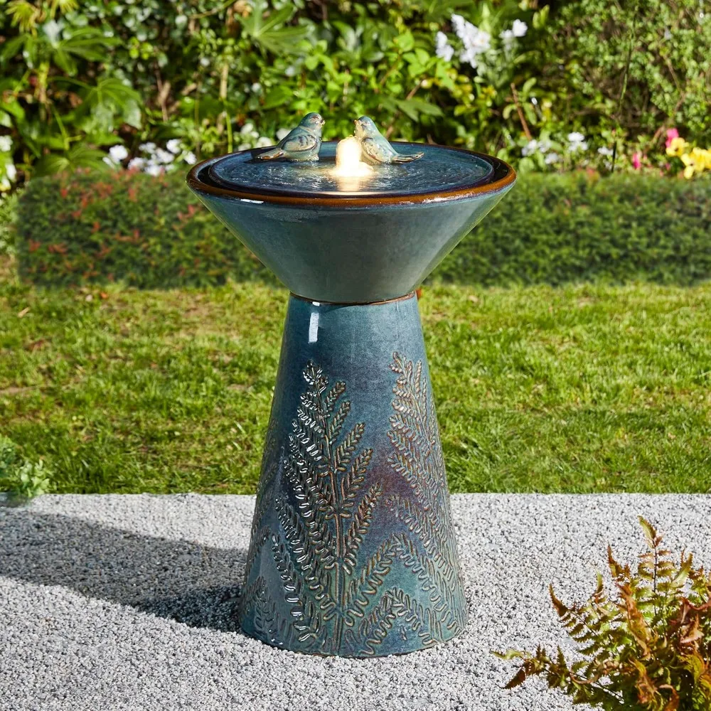 Turquoise ceramic outdoor fountain with birds and leaves