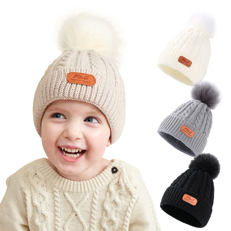 

Baby Winter Cap Big Fur Ball Twist Girls Knitted Hats Warm Woolen Caps Solid Color Boys Beanie Fashion Leather Label Accessories