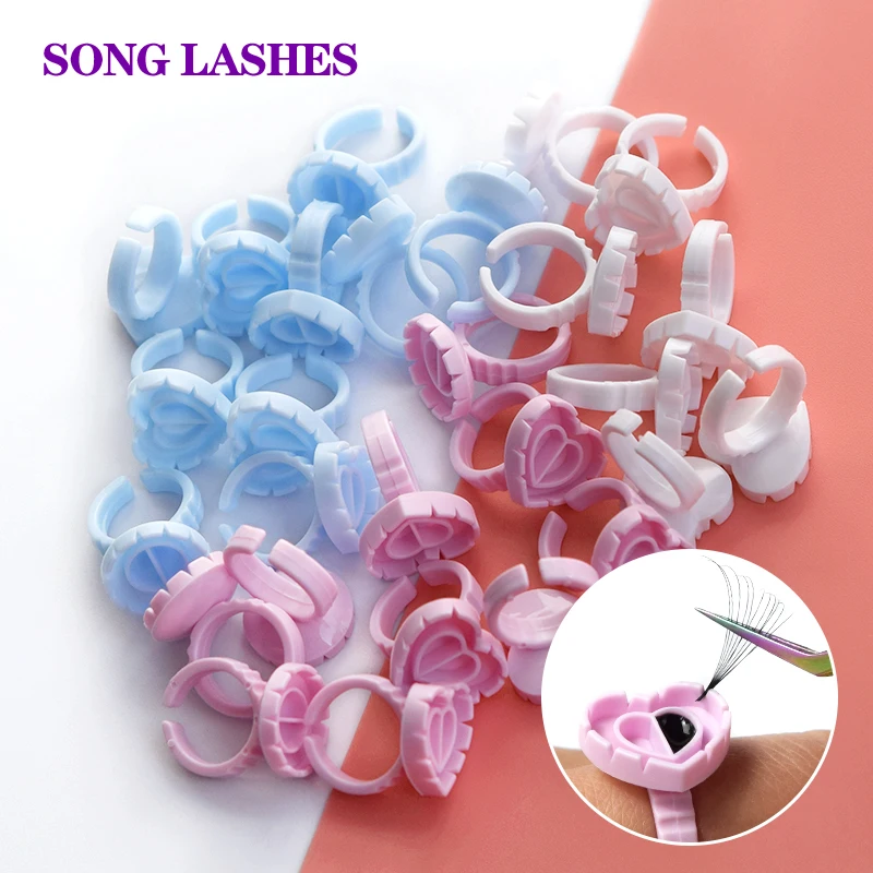 

Songlashes Blue Pink White 100Pcs Disposable Eyelash Heart Shape Glue Ring Cup Holder Container Eyelash Extension Makeup Tools