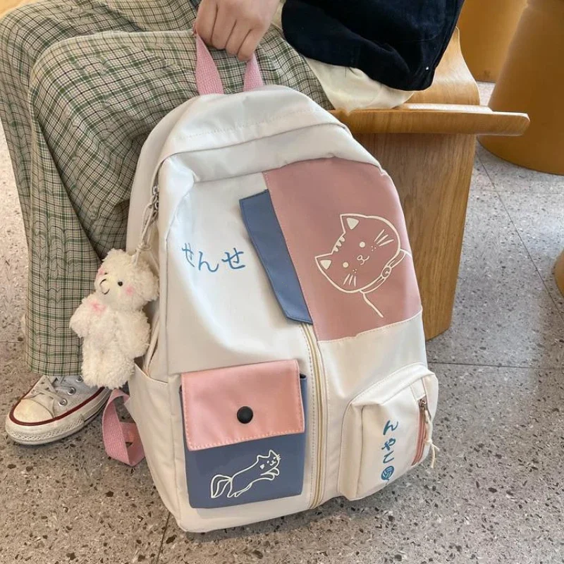 Korean cute cartoon cat woman backpack for high school students, large capacity waterproof nylon travel bag.