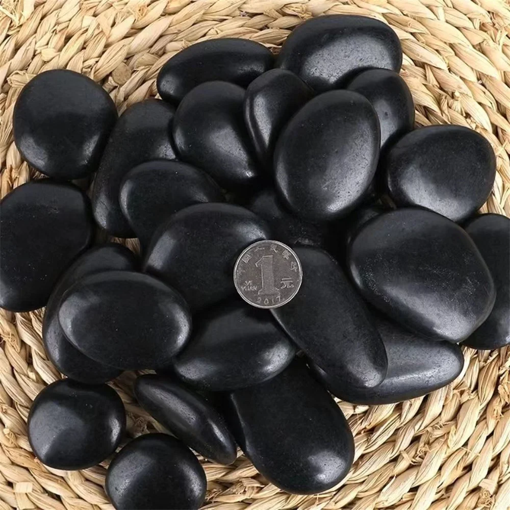 Natural Shungite irregular tumbled stones with a deep black color and smooth, polished surface.