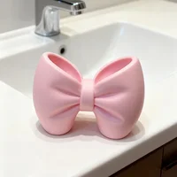 A desktop decoration item, shaped like a macaron-colored bow, can be used as a pen holder. 5