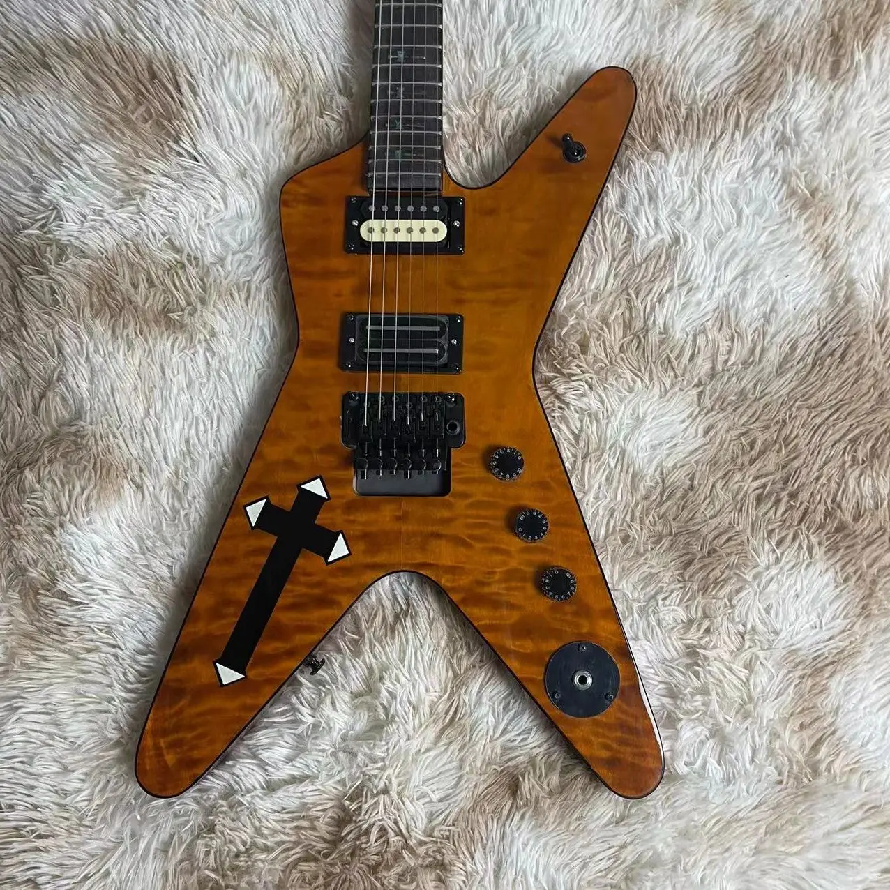 

Irregular large fork integrated electric guitar, light brown body with cross inlay, rose wood fingerboard, tremolo drawstring bo