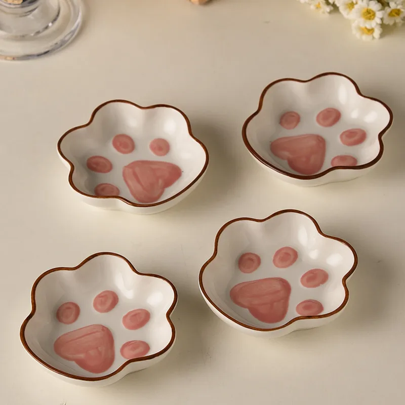 Ceramic flavored dishes, cat claw shaped sauce dishes, and small bowls of tomato sauce