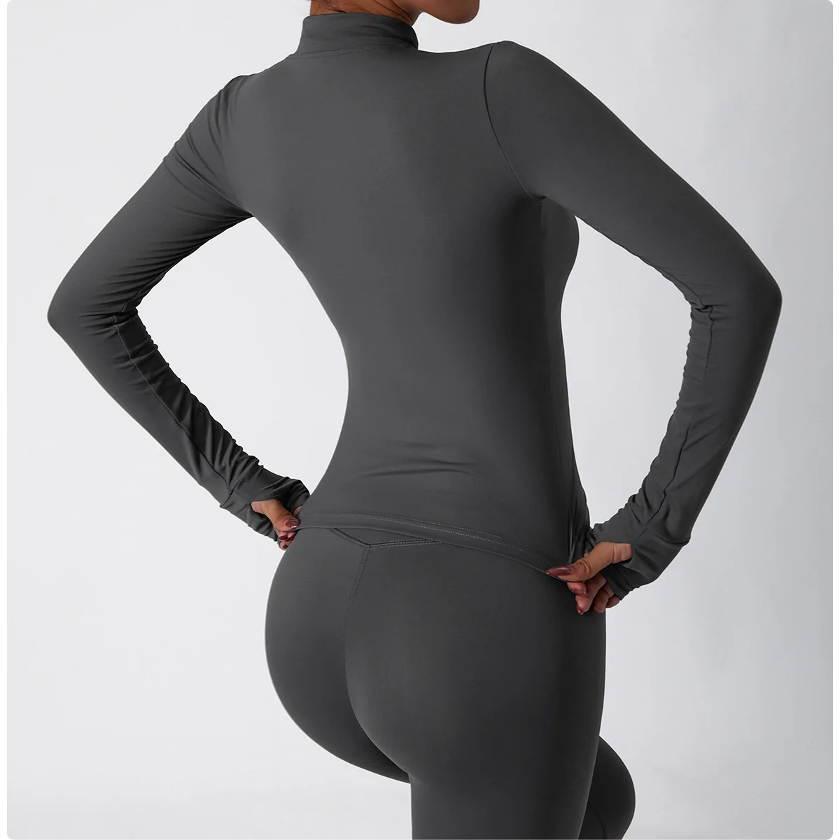 The backview of a woman wearing a brown women's tracksuit set sold by 100 Spartans