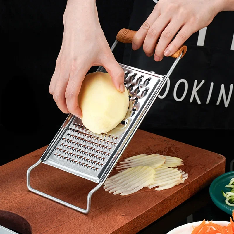 Stainless steel multifunctional vegetable grater and pulp separator tool.