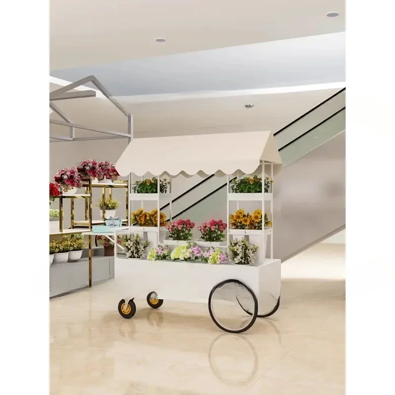 Setting up stalls, selling flower carts, pushing racks, displaying flower art in houses, shelves, and display ra