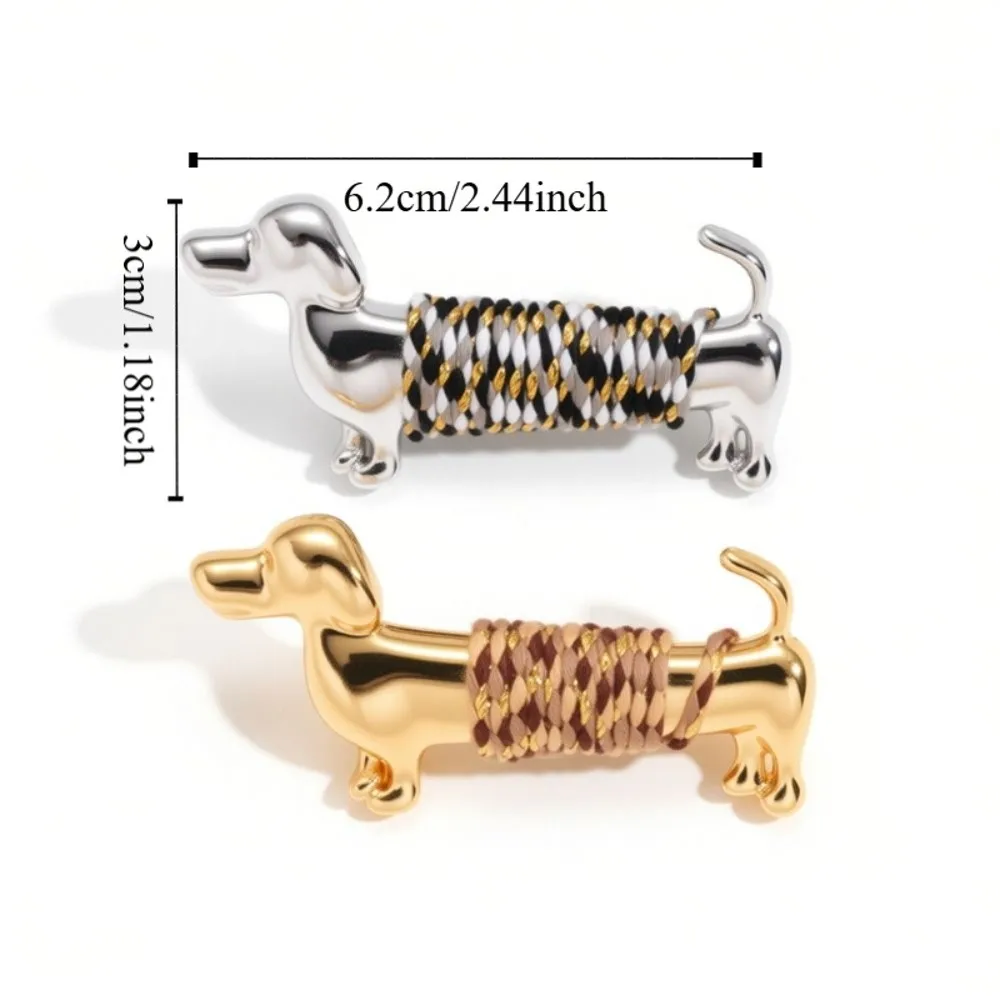 Polished gold and silver luxury sausage dog lapel brooch pins styled on a black wool blazer collar and a white business suit next to a size dimension chart