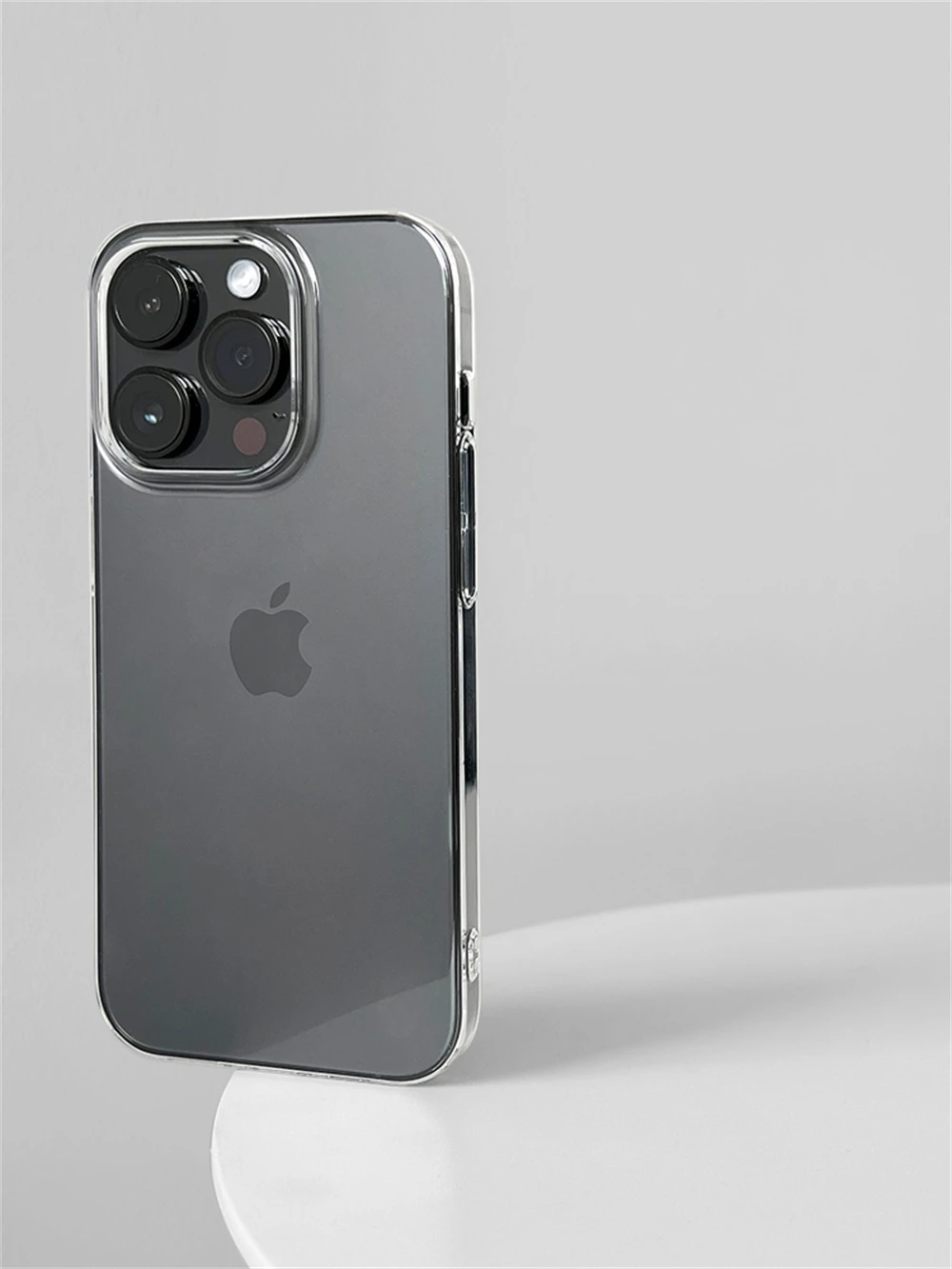 Silver iPhone with Apple logo on a light gray background