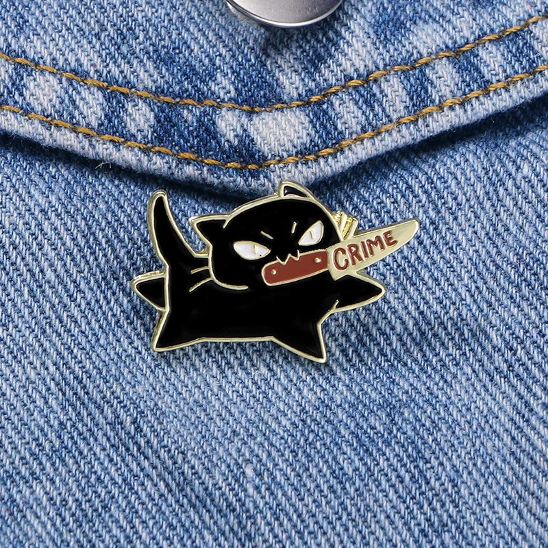 KittyNook Cat Co. Cute Black Cat Enamel Brooch—cat with "CRIME" knife, perfect for denim or jackets.