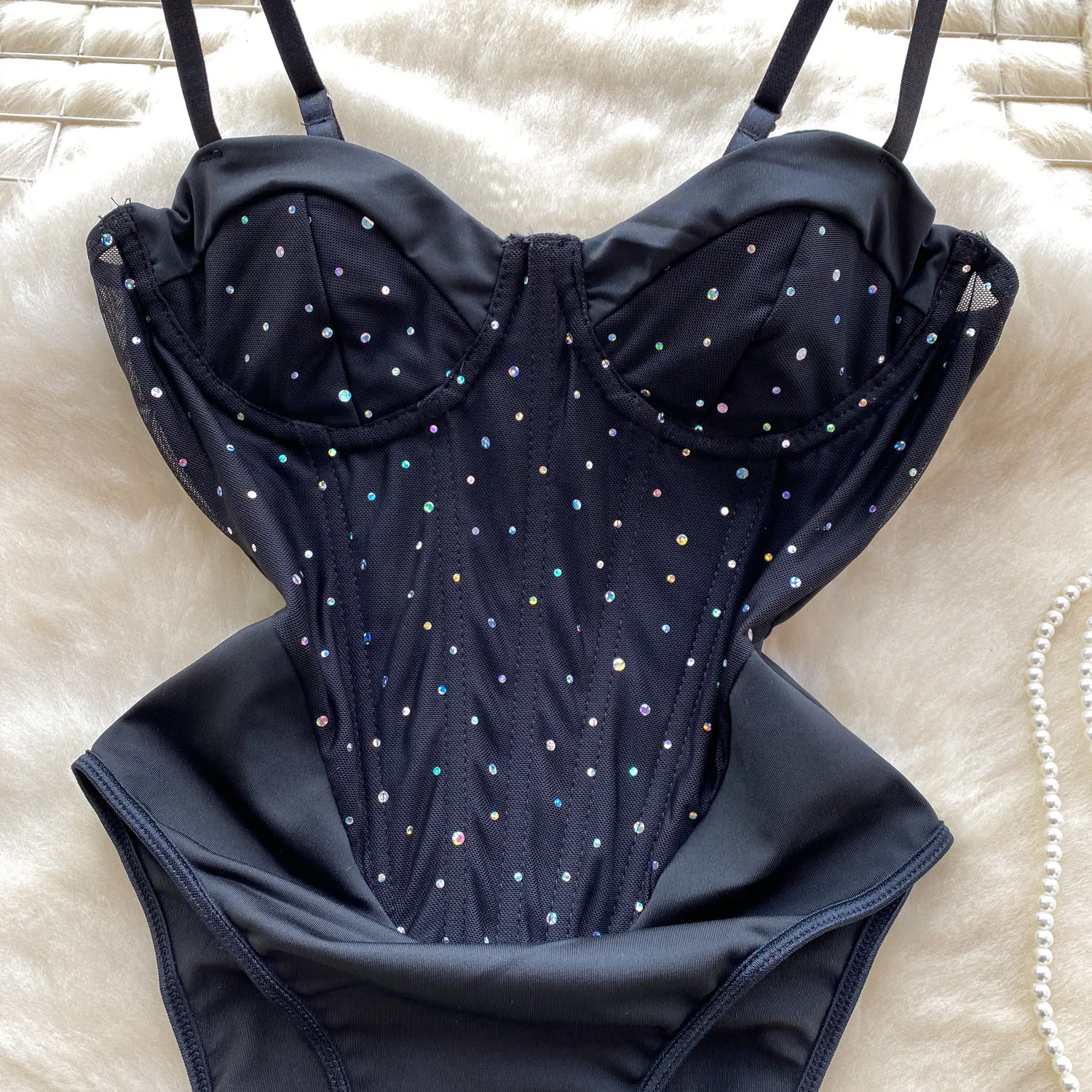 strappy shoulder detail on black bodysuit