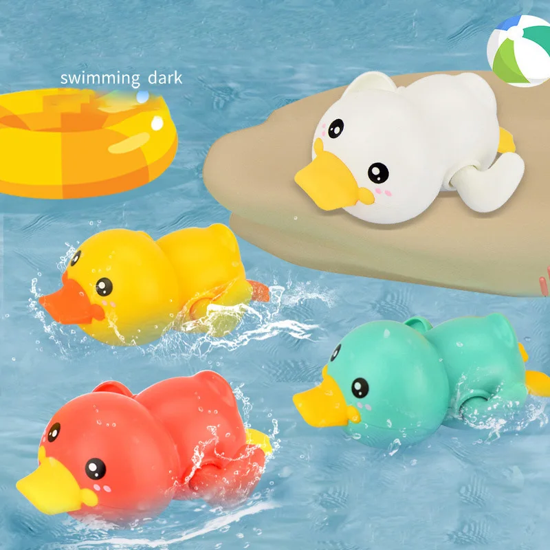

Playing with water bathing with toys for children babies on the beach babies small yellow ducks swimming animals