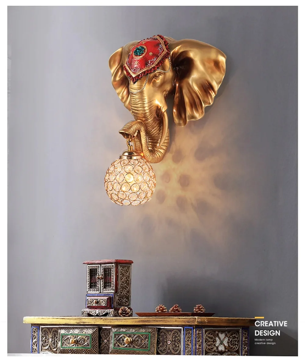 Enhance your space's ambiance with the 3D Elephant Wall Light, featuring a decorative bulb. This exquisite lamp elegantly complements an ornate cabinet adorned with charming trinkets, adding sophistication to any room.