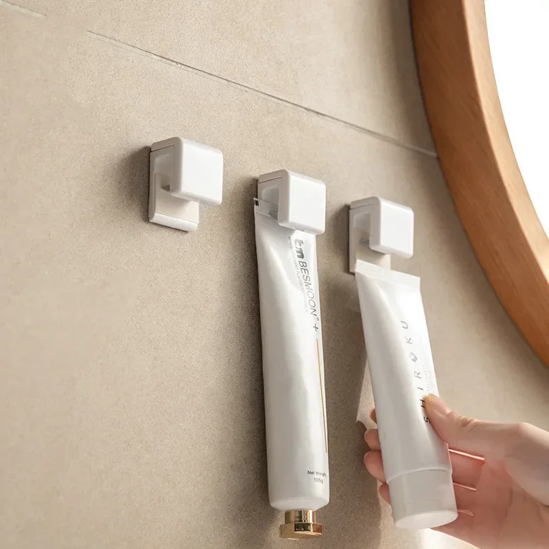 New Toothpaste Rack Self-adhesive Facial Cleanser Hanging Clip Seamless Bathroom Storage Holders Bathroom Wall Hook Holder Clip