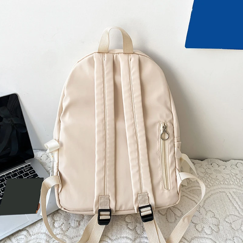 Stylish kawaii backpack with bowknot detail, designed for women and girls, featuring soft pastel tones and spacious compartments for school essentials. beige back