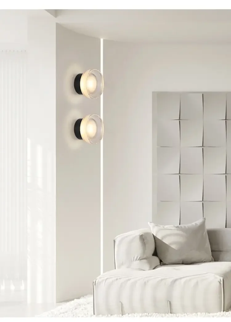 Circular wall lamp above bedside table