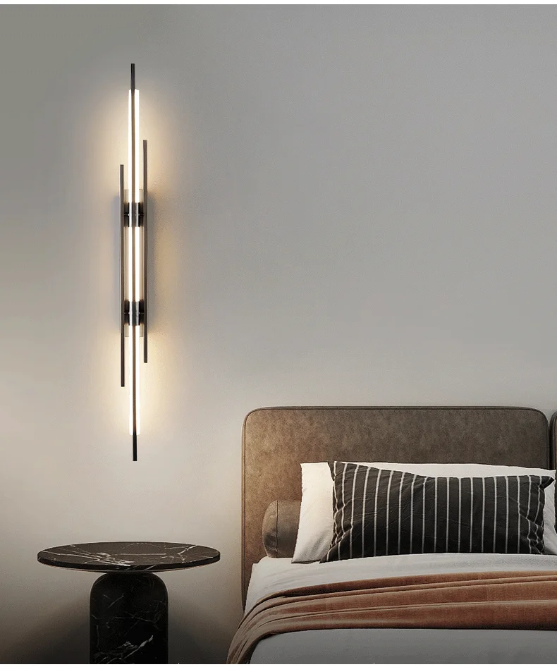 A modern bedroom with a bed featuring contemporary lighting and a bedside lamp.