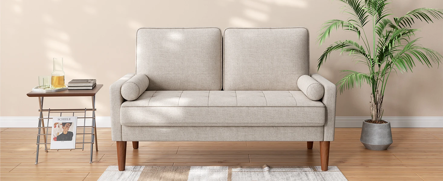 Light grey two-seater sofa with tapered wooden legs, accompanied by side table and decorative potted palm plant.