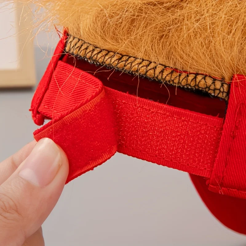 A close-up of a hand adjusting the red Velcro strap on the Visor Cap - Make America Great Again, featuring attached light brown synthetic hair—a bold patriotic conversation starter.