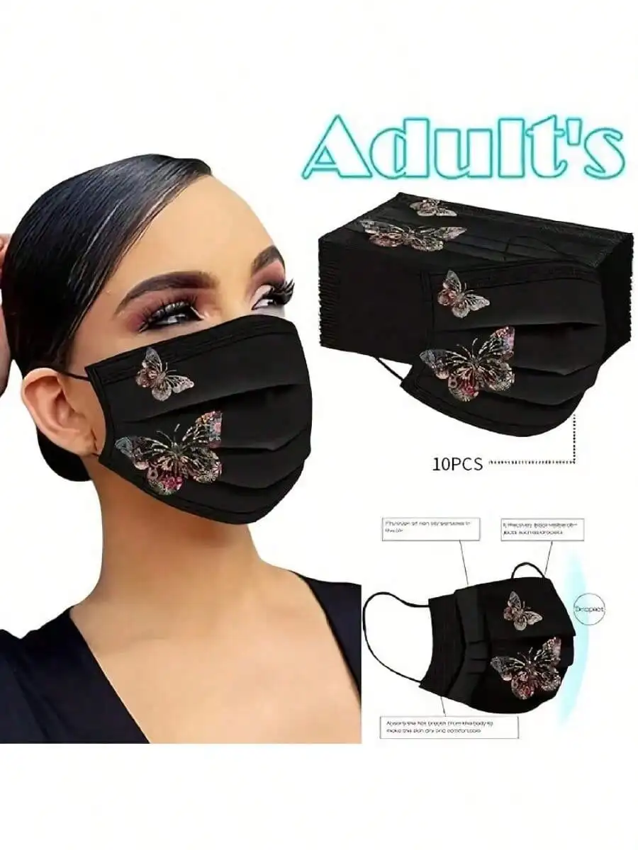 Lot de trois masques réutilisables en tissu avec motifs papillons colorés sur fond blanc, présentés à plat.