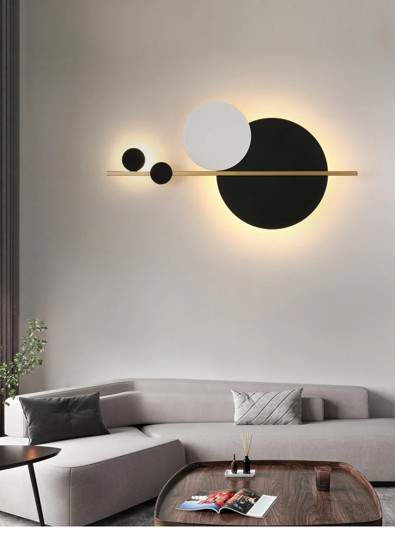 A minimalist living room with black and white circles on the wall of the living room.