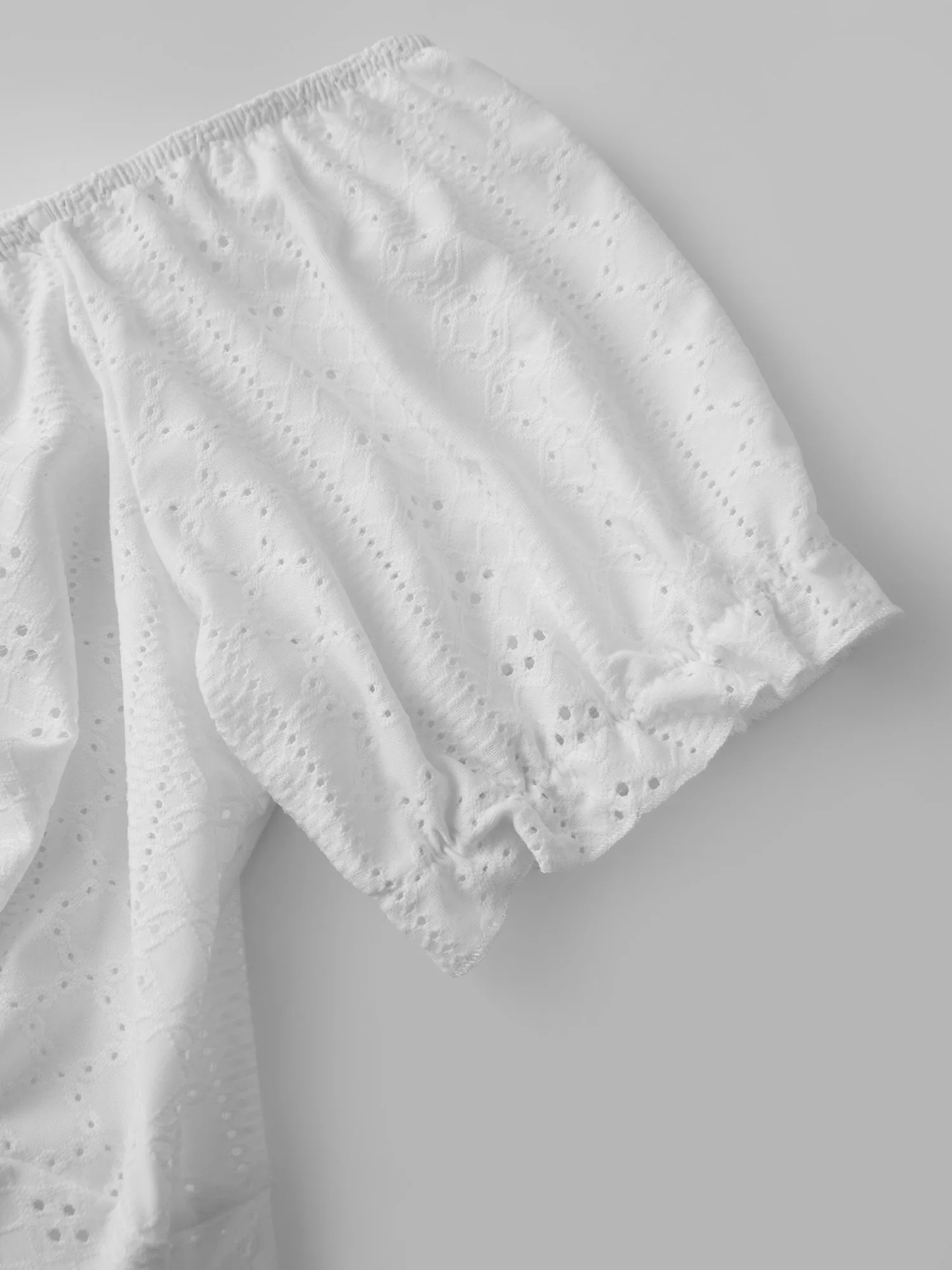 Stylish Women s Off Shoulder Blouse with Short Puff Sleeves and Tie Up Detail Featuring Irregular Hem and Eyelet Design in