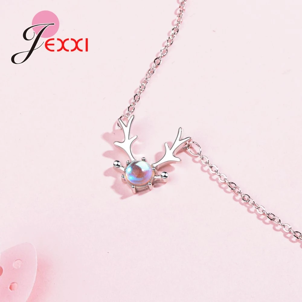 Sterling silver deer antler necklace featuring a central iridescent moonstone pendant.