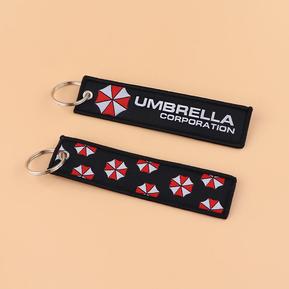 1 Stück Umbrella Corporation bestickte Schlüsselanhänger Schlüsselanhänger für Frauen Schlüsselanhänger japanische Anime Autoschlüssel Zubehör Geschenke